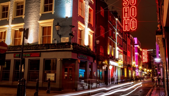 A street lit up at night in Soho London